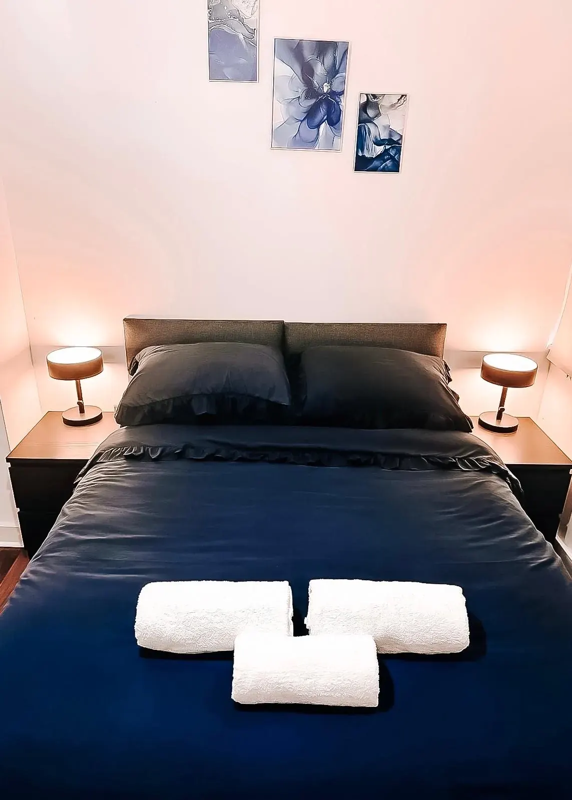 The bedroom set up with one large double bed and bedside lamps