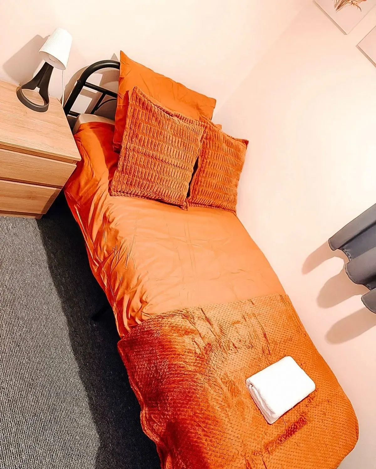 The single bed with a folded towel
