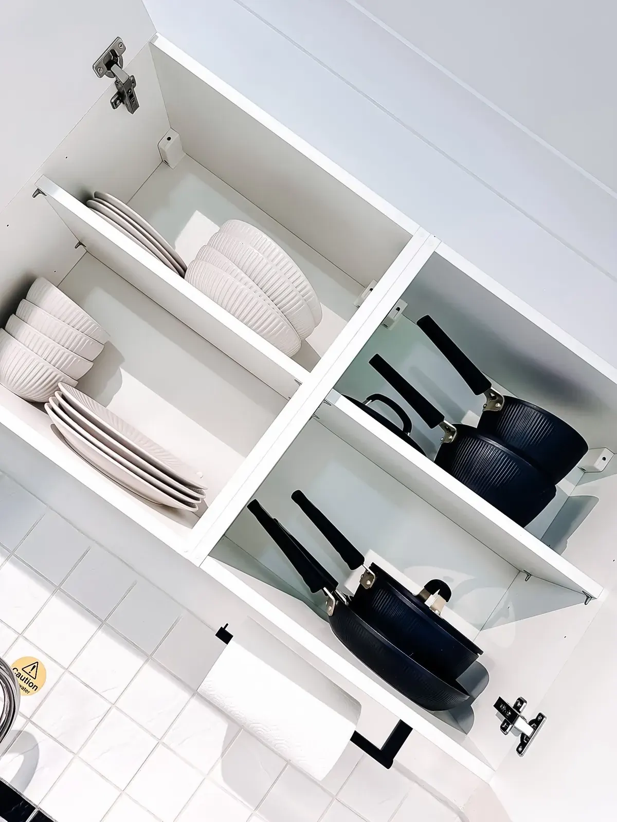 Crockery and pans in the kitchen cupboard
