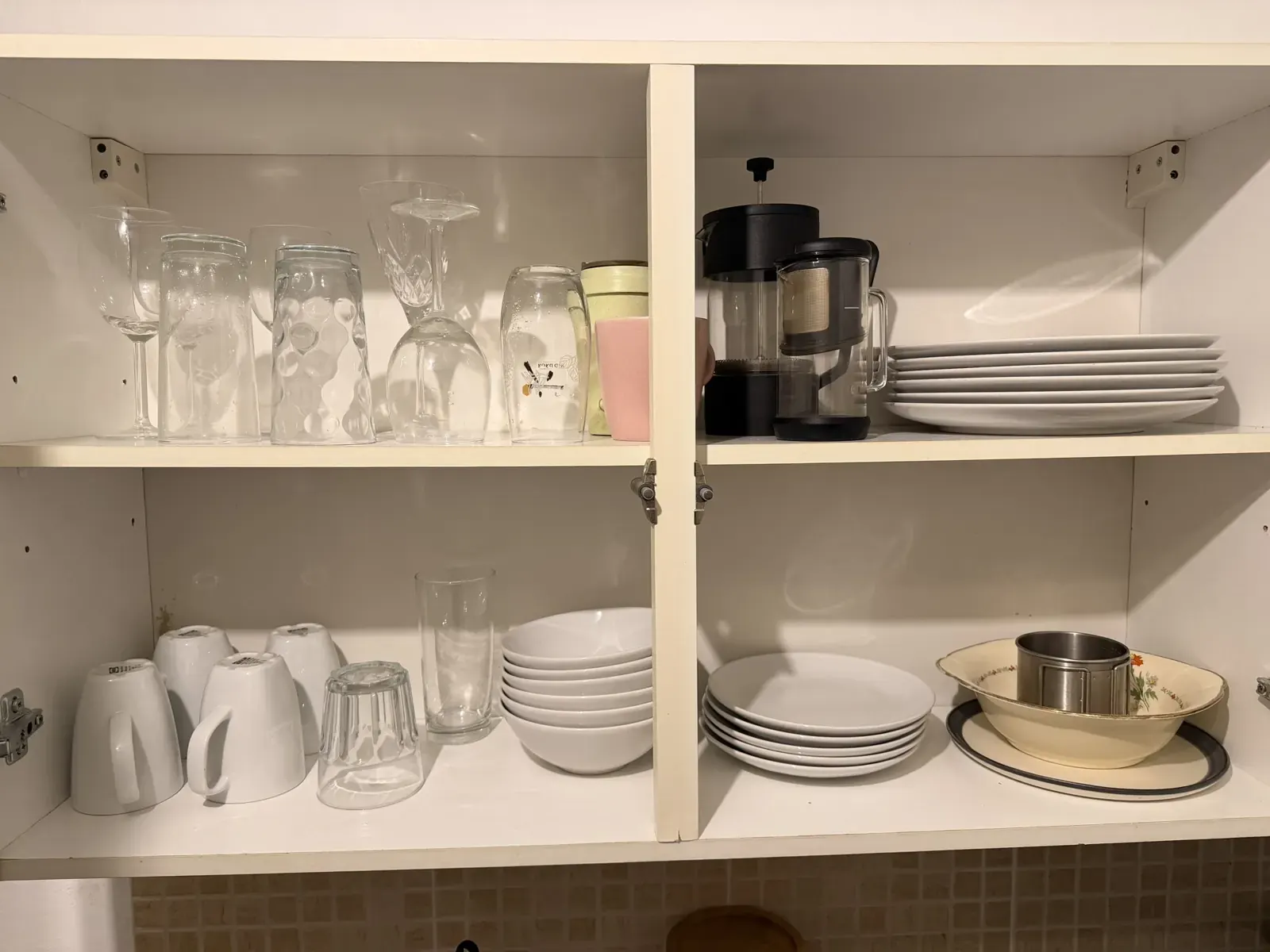Glasses and crockery in the kitchen cupboard